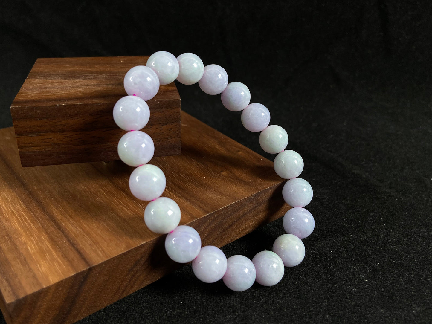 A jade bead strand in a uniform creamy white color.