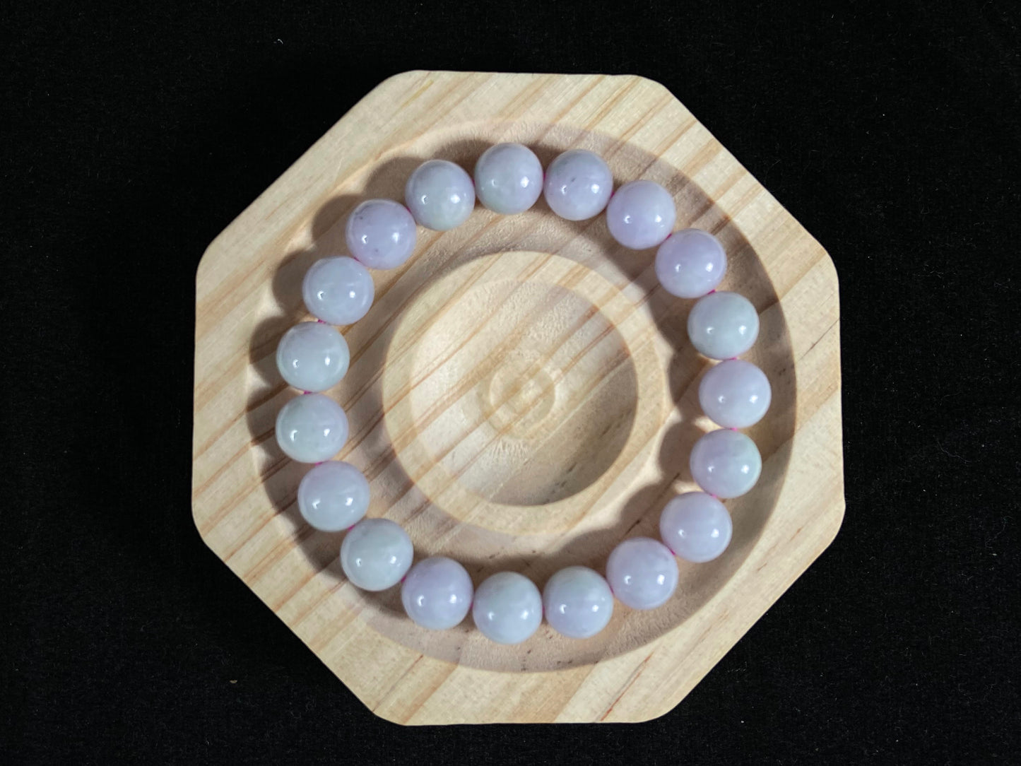 A jade bead strand in a uniform creamy white color.