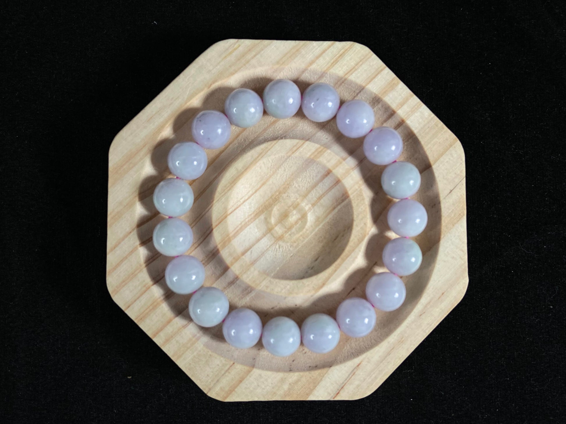 A jade bead strand in a uniform creamy white color.