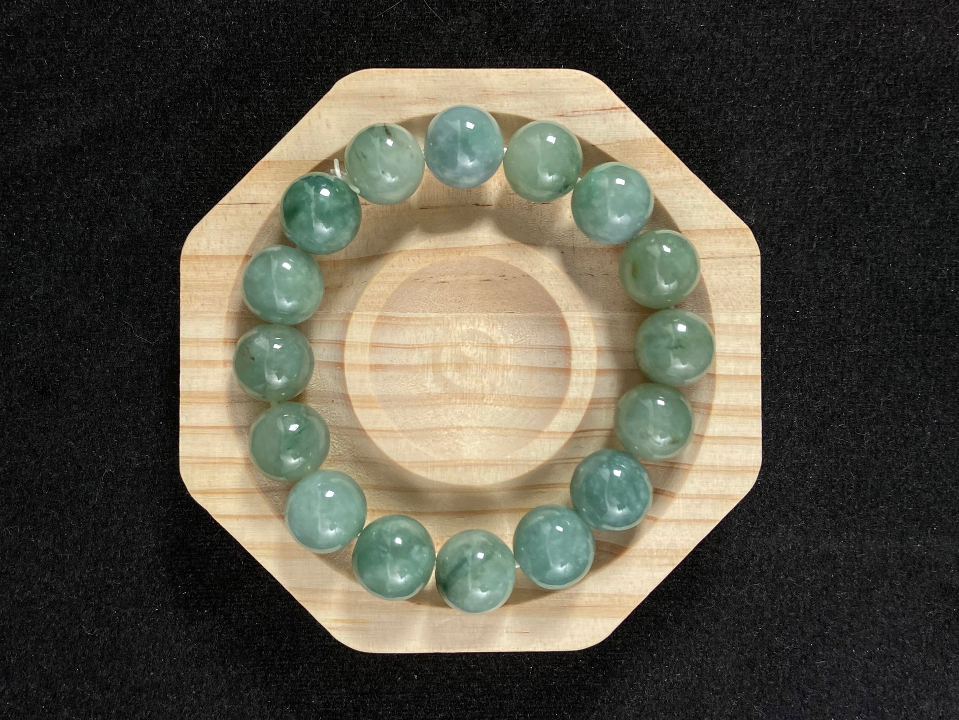 A jade bead strand with a blue base color.