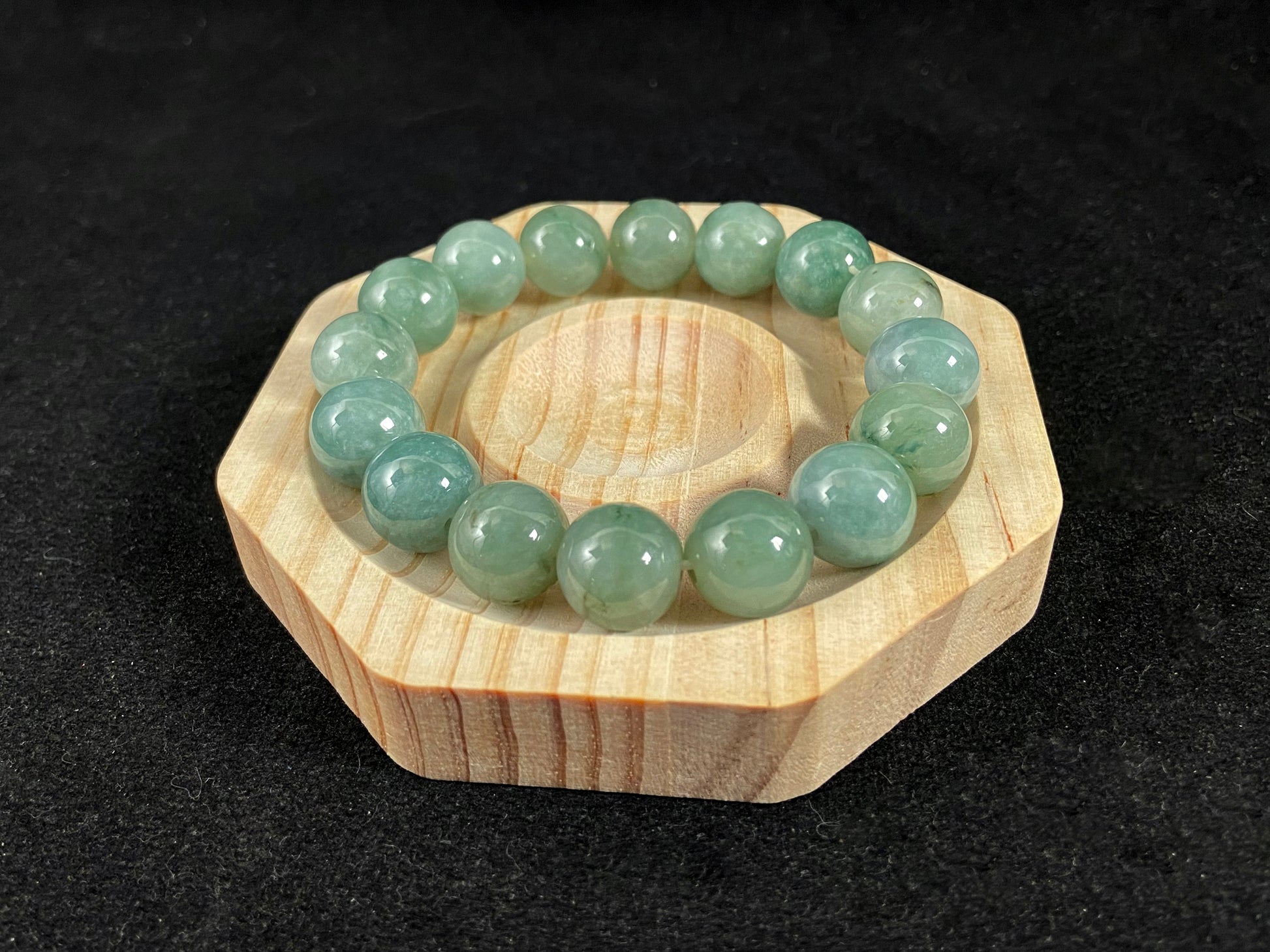 A jade bead strand with a blue base color.