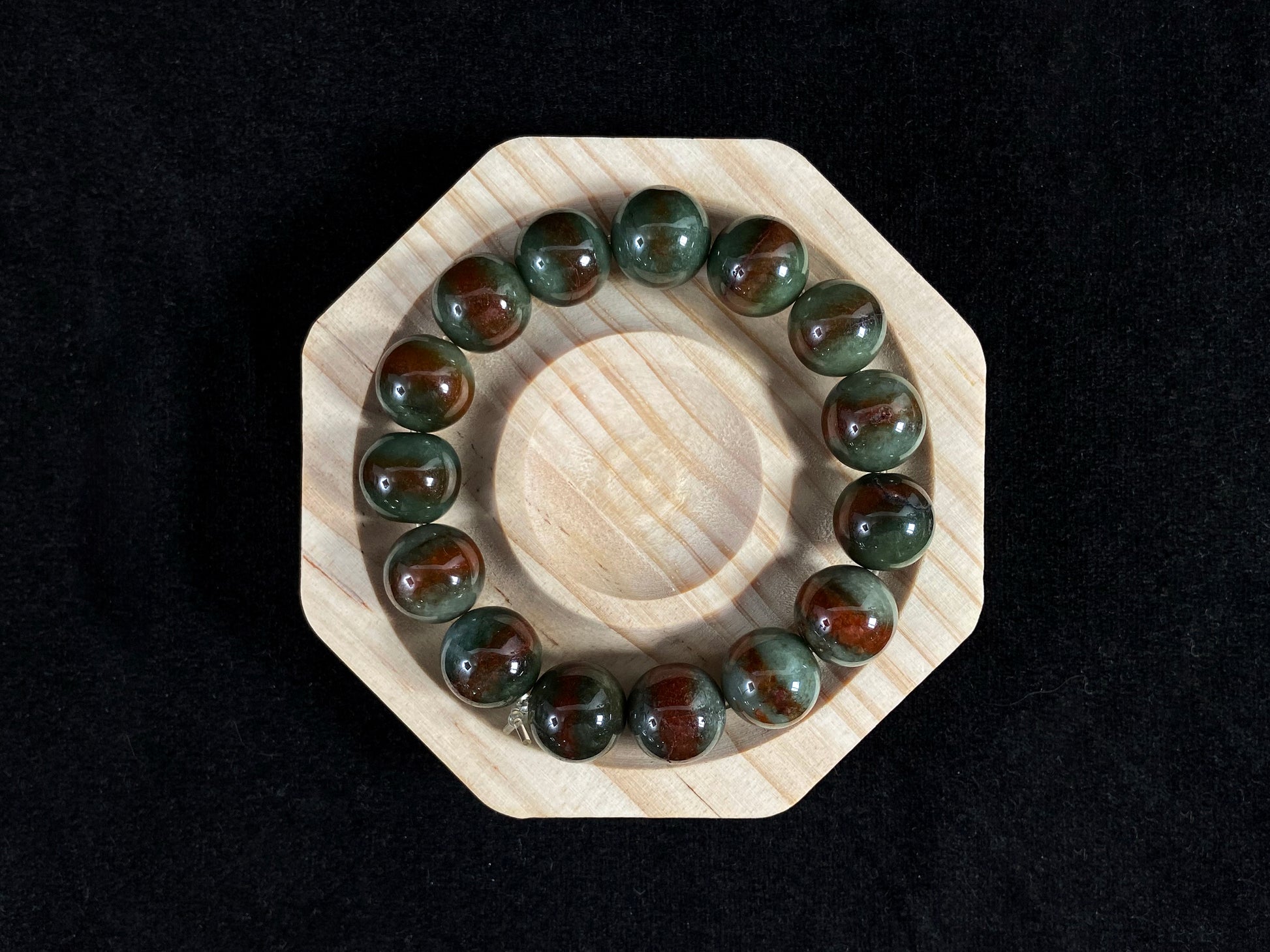 Forest green jade beads with vibrant vermilion accents.