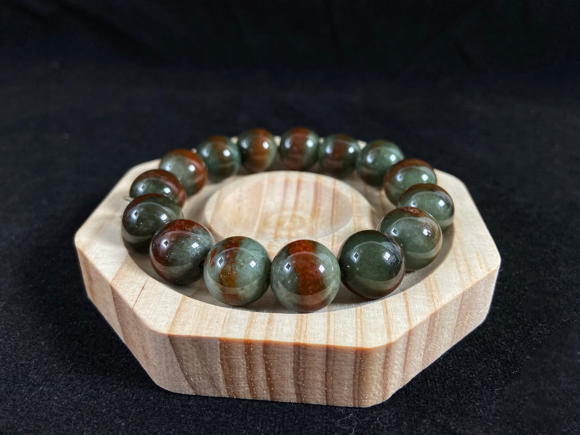 Forest green jade beads with vibrant vermilion accents.