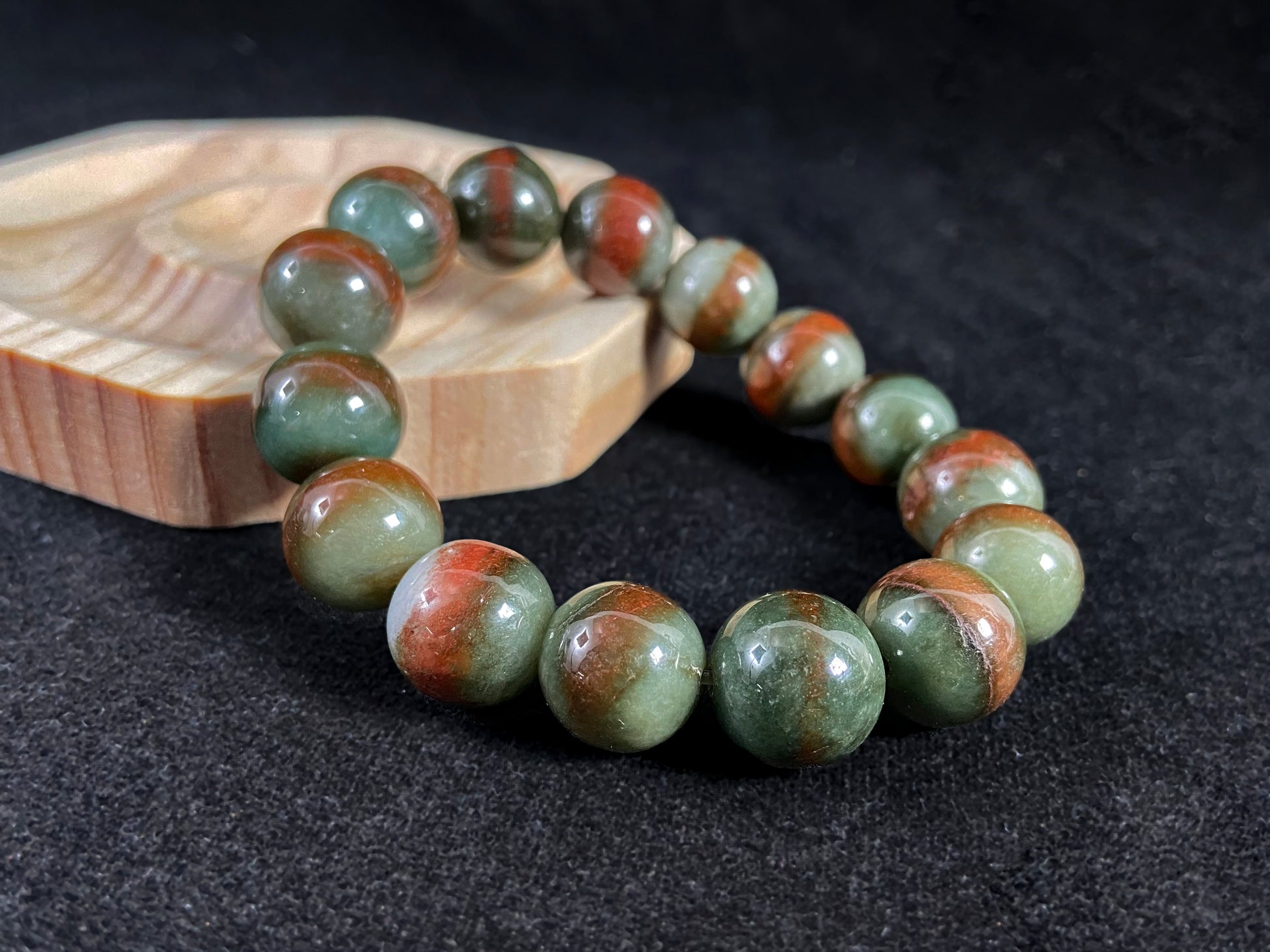 Forest green jade beads with vibrant vermilion accents.