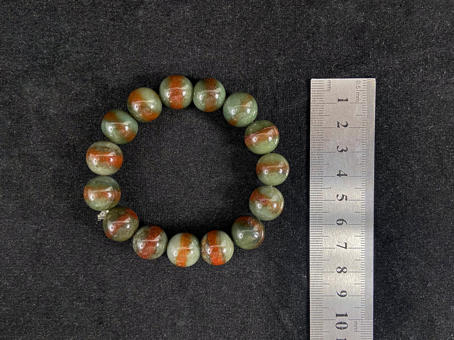 Forest green jade beads with vibrant vermilion accents.