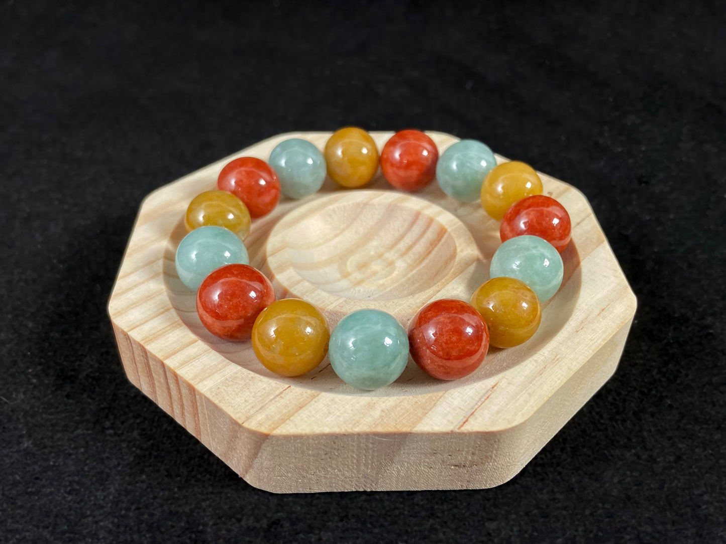 A jade bead strand blending burgundy, yellow, and pale greenish white tones.