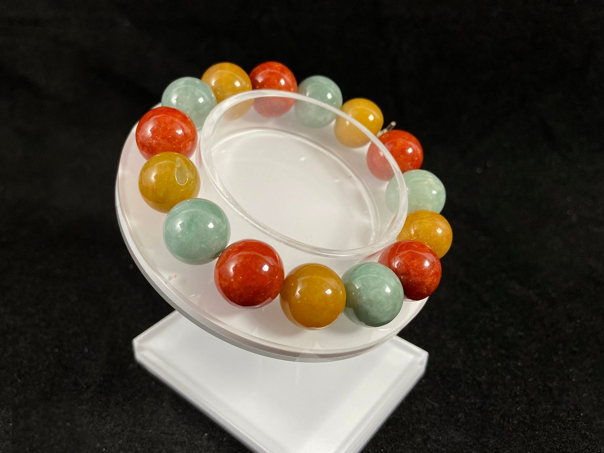 A jade bead strand blending burgundy, yellow, and pale greenish white tones.