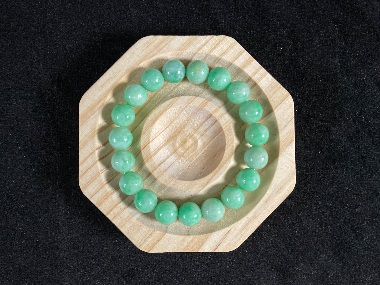 A jade bead strand featuring apple green tones.