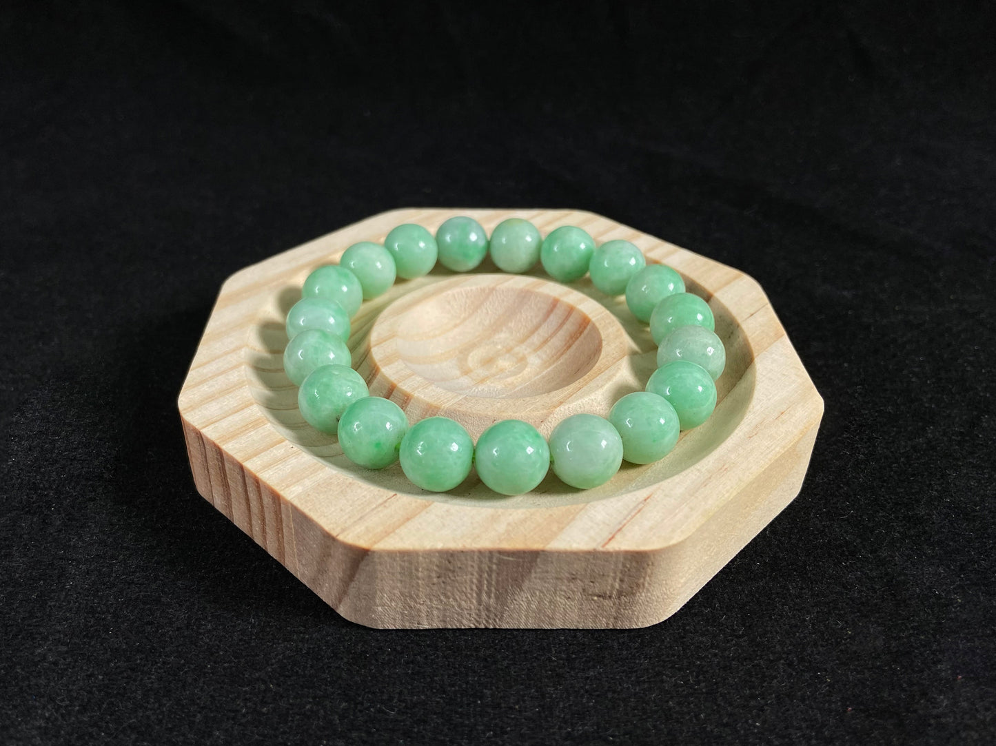 A jade bead strand featuring apple green tones.