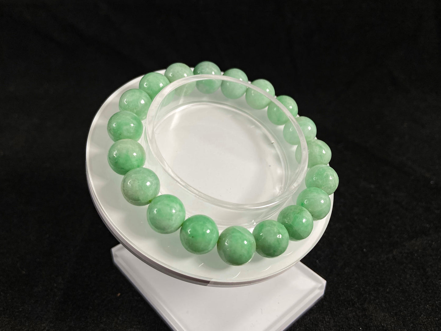 A jade bead strand featuring apple green tones.