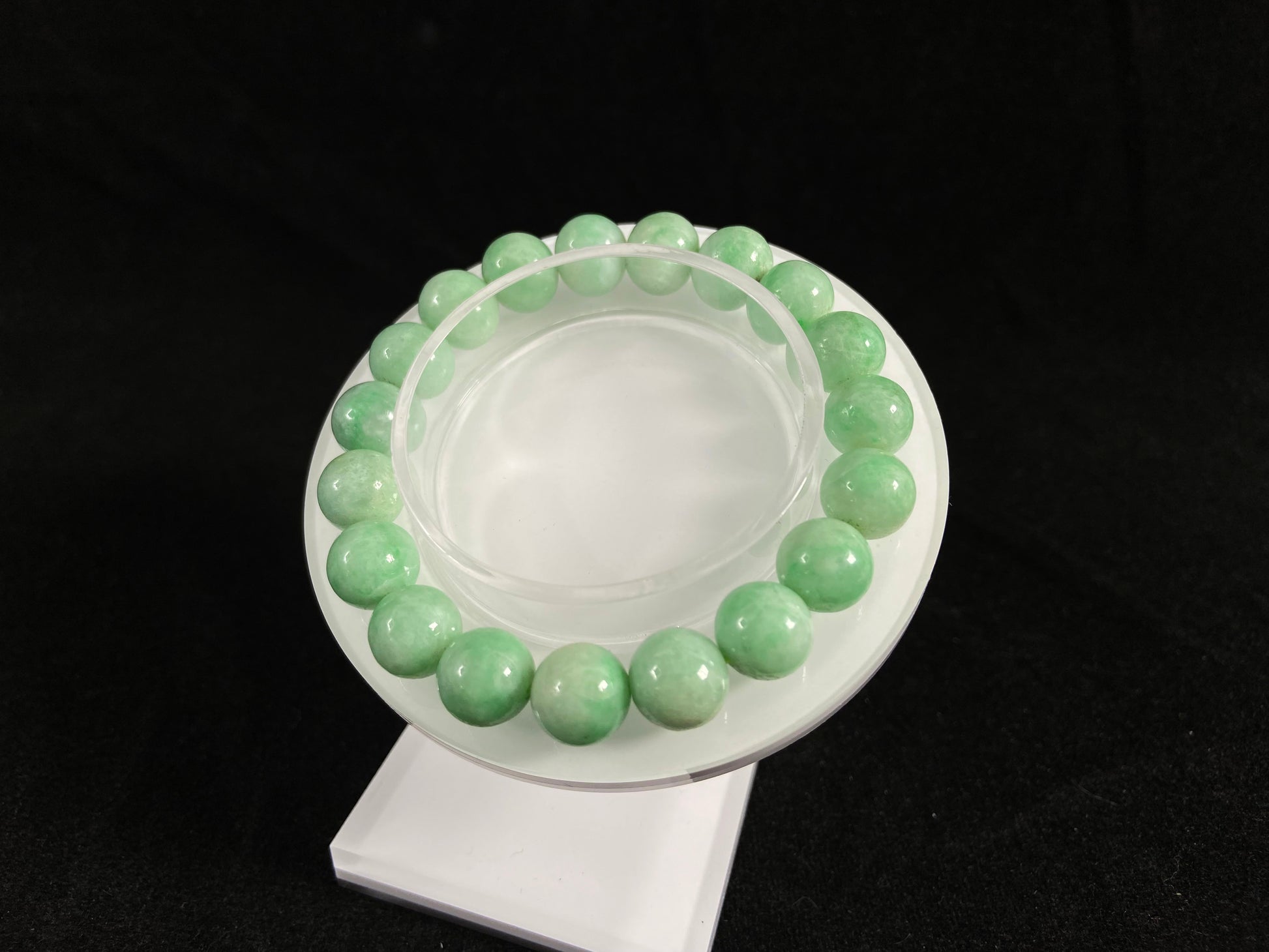 A jade bead strand featuring apple green tones.