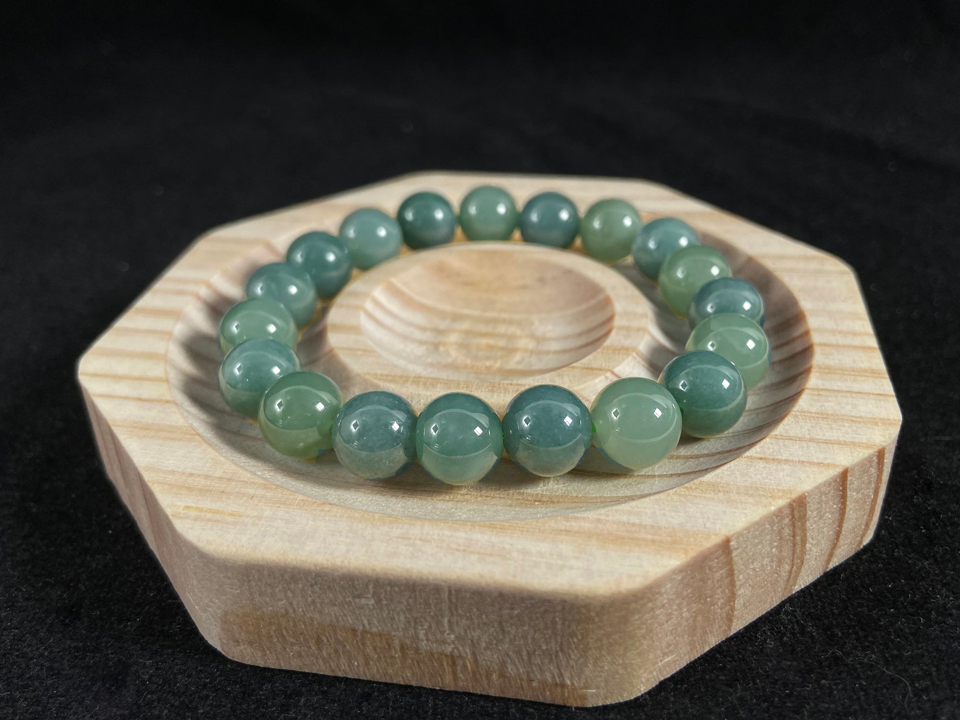 This jadeite bead strand has uniformly sized beads, including translucent pale green ones and opaque green ones.