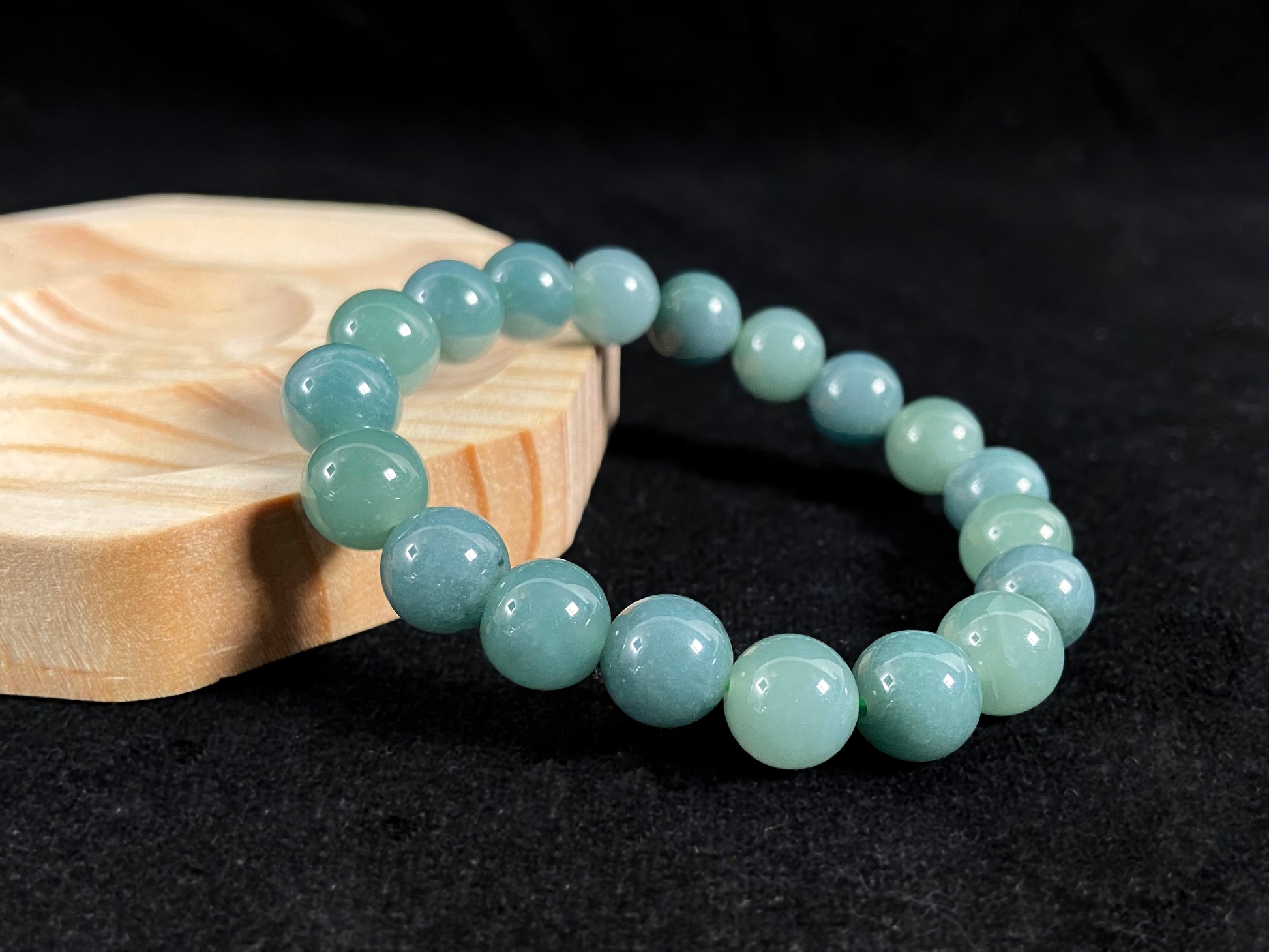 This jadeite bead strand has uniformly sized beads, including translucent pale green ones and opaque green ones.