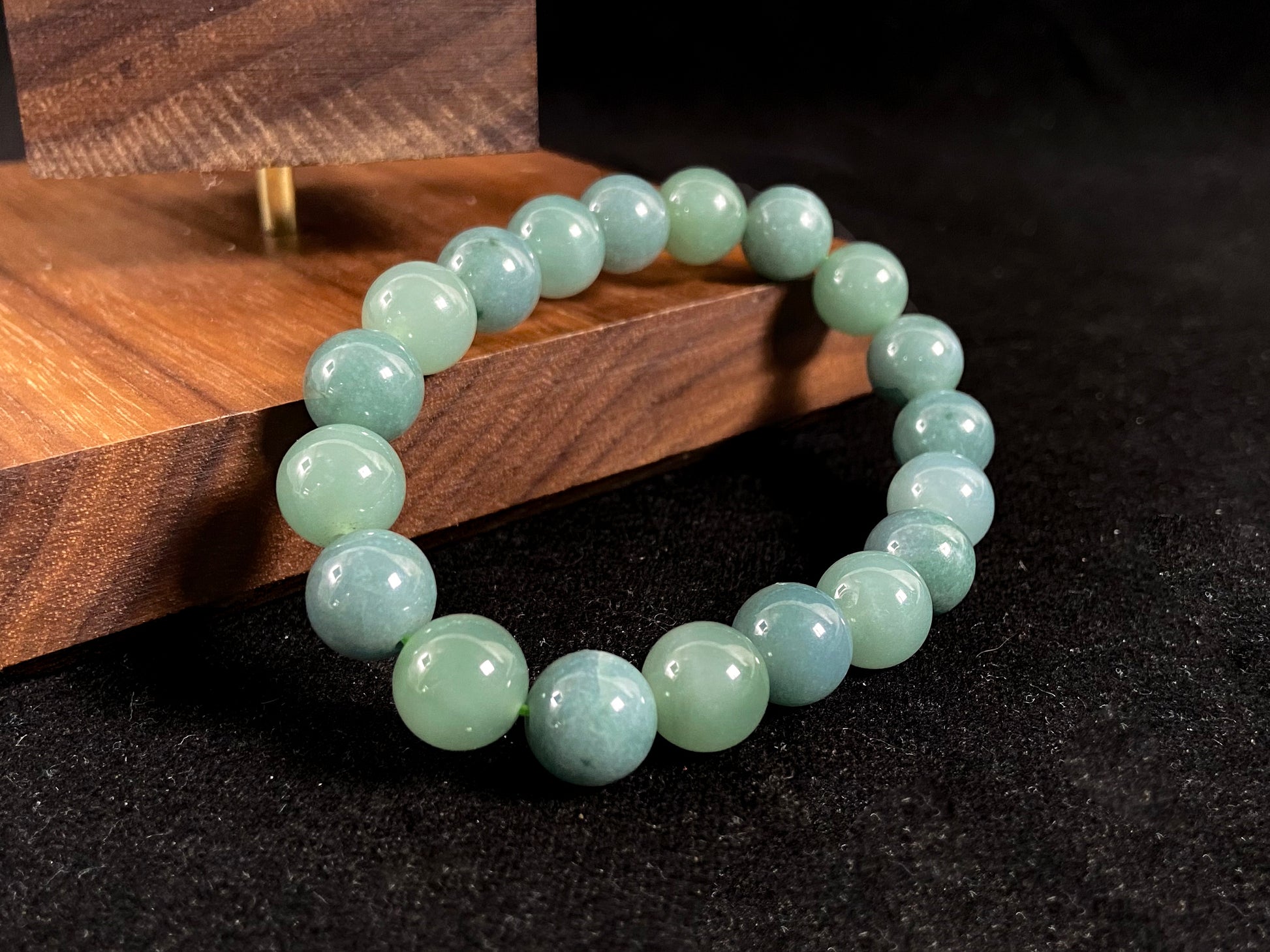 This jadeite bead strand has uniformly sized beads, including translucent pale green ones and opaque green ones.