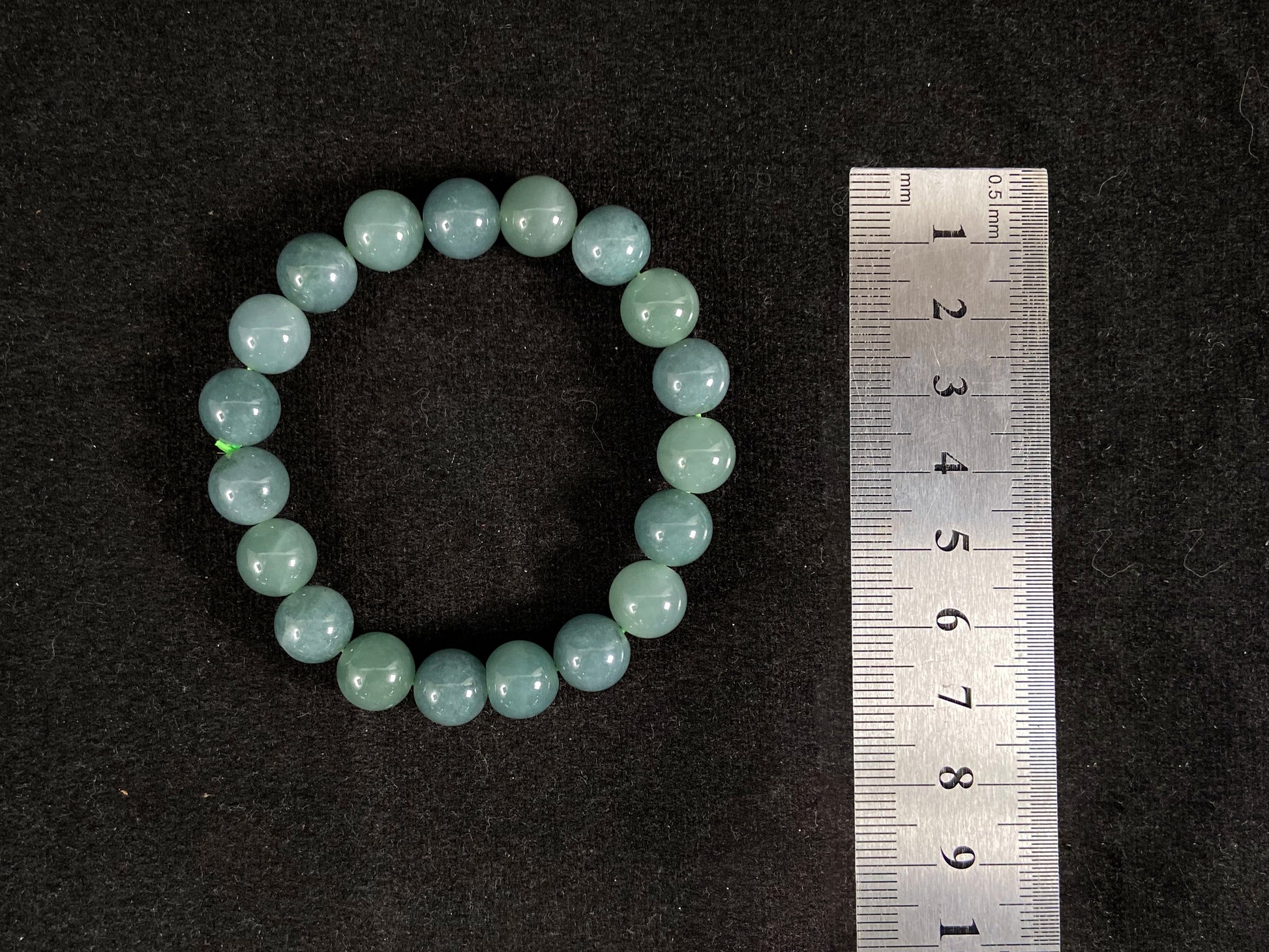This jadeite bead strand has uniformly sized beads, including translucent pale green ones and opaque green ones.
