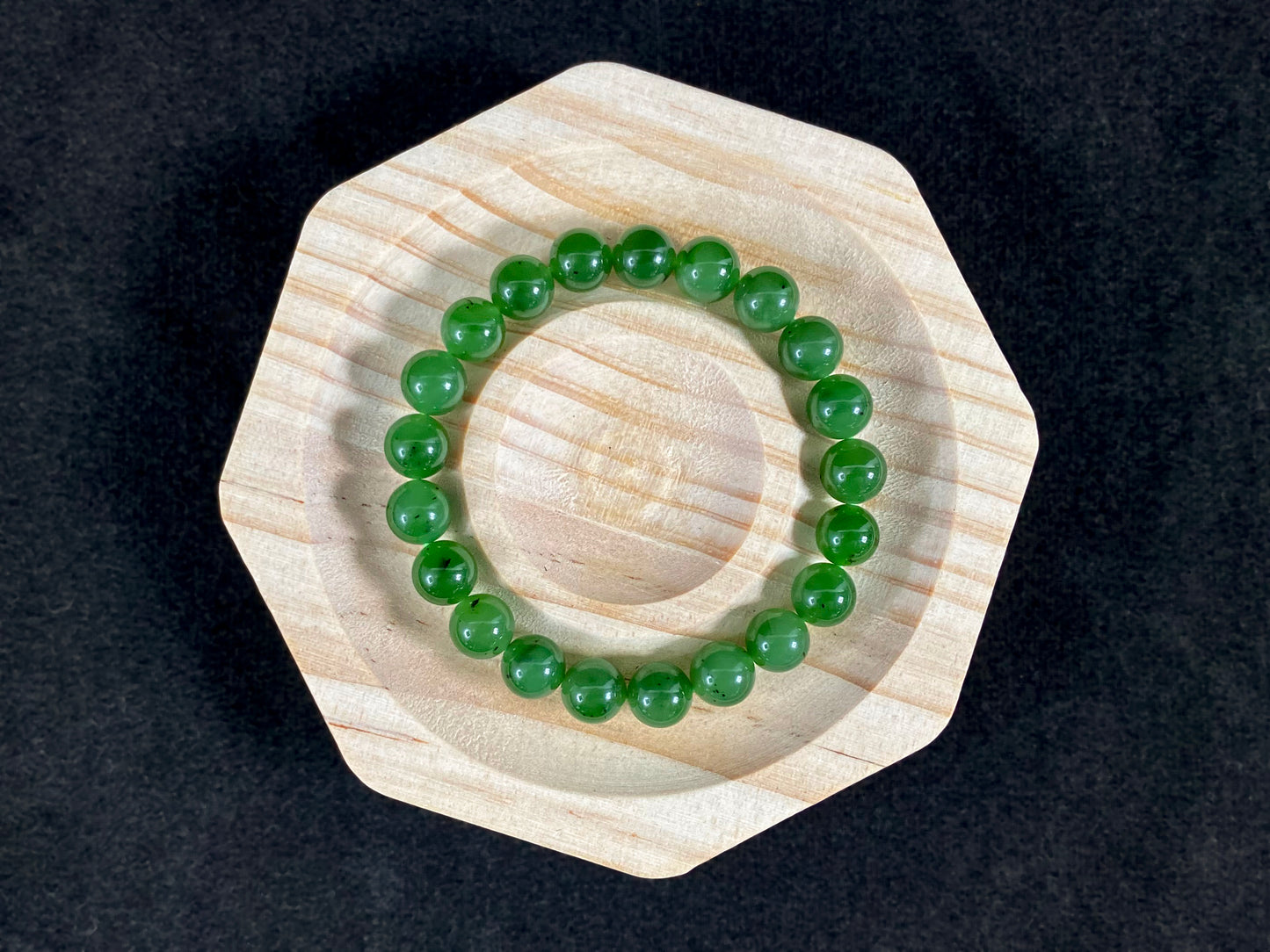A strand of vibrant green jade beads.