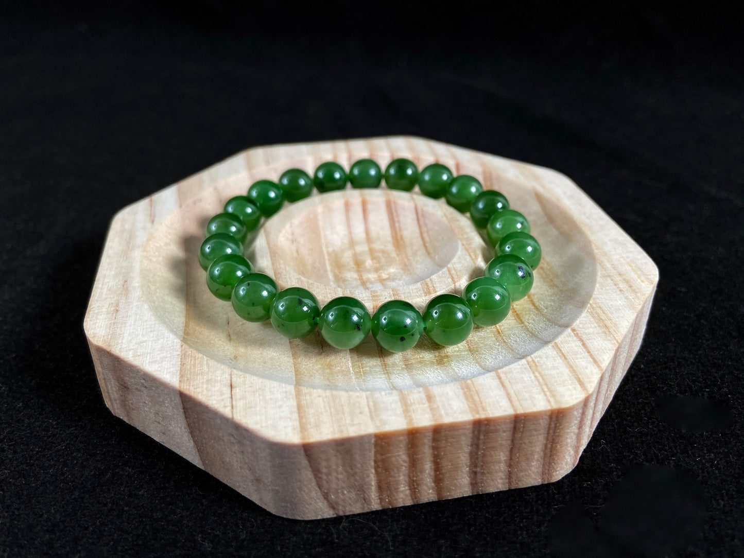 A strand of vibrant green jade beads.