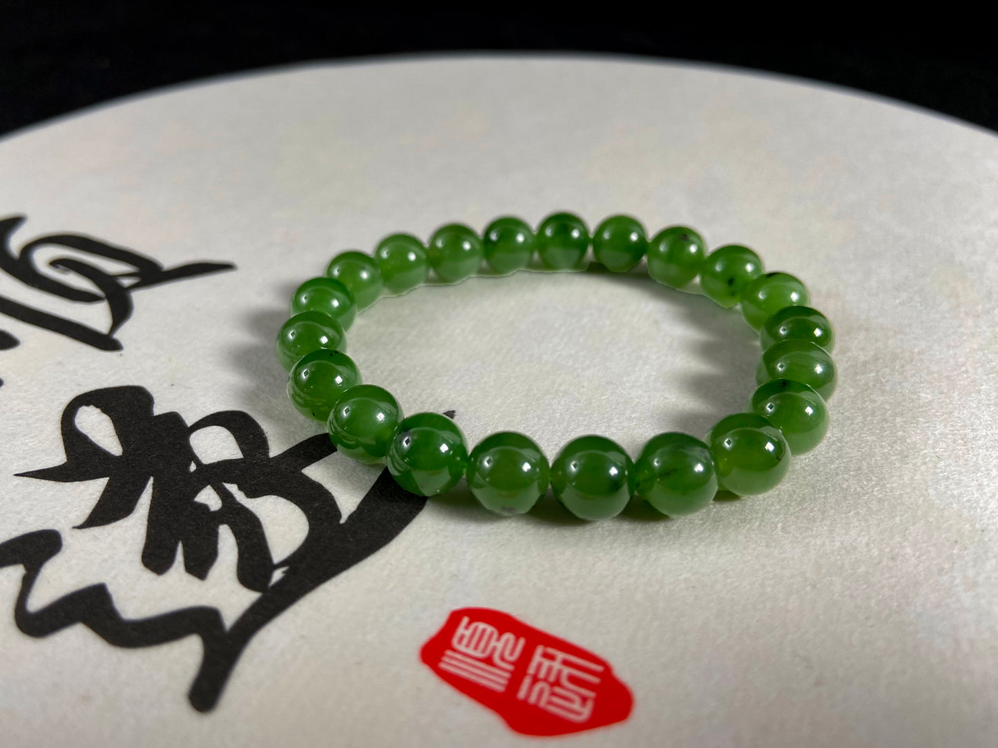 A strand of vibrant green jade beads.