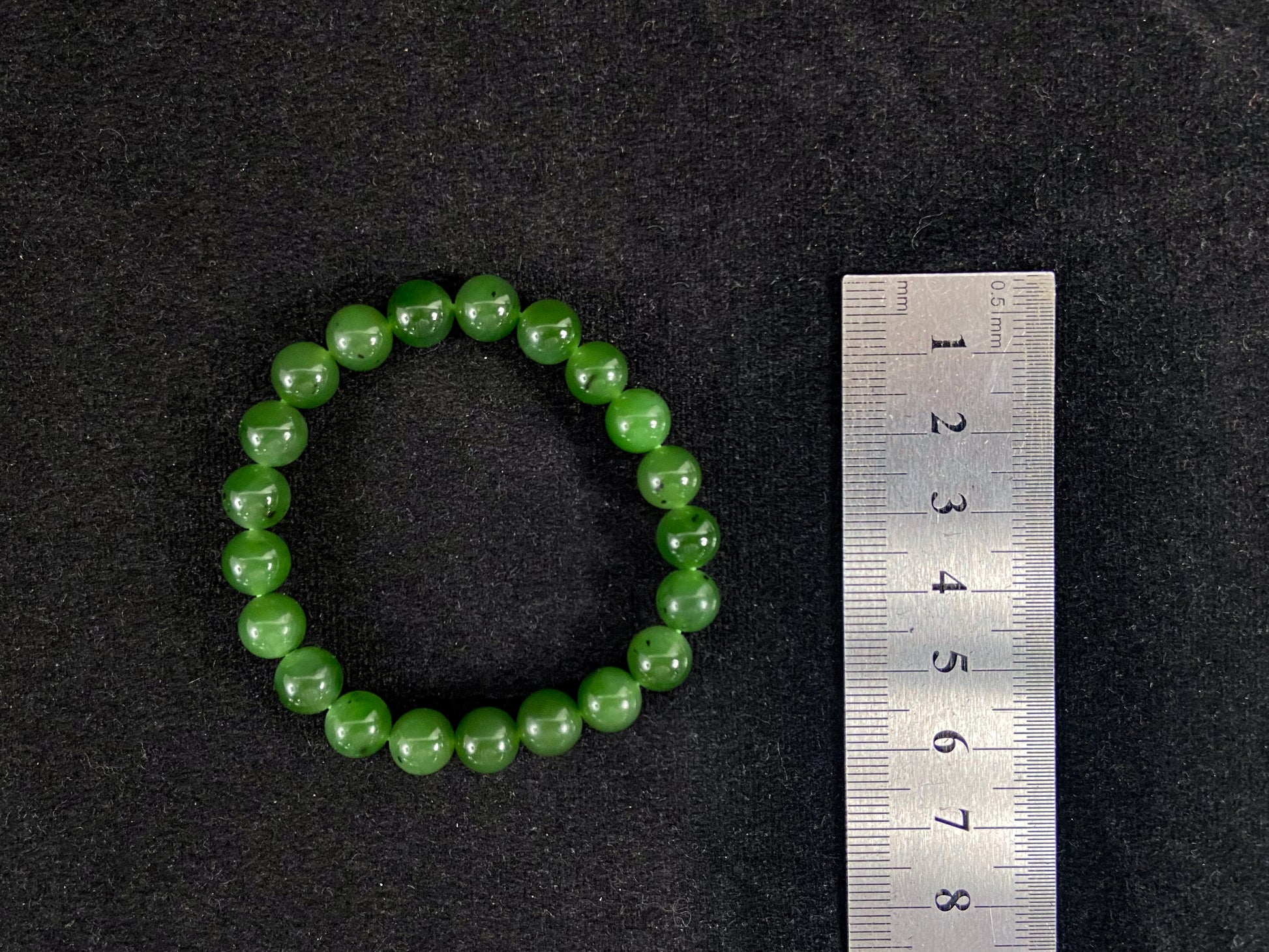 A strand of vibrant green jade beads.
