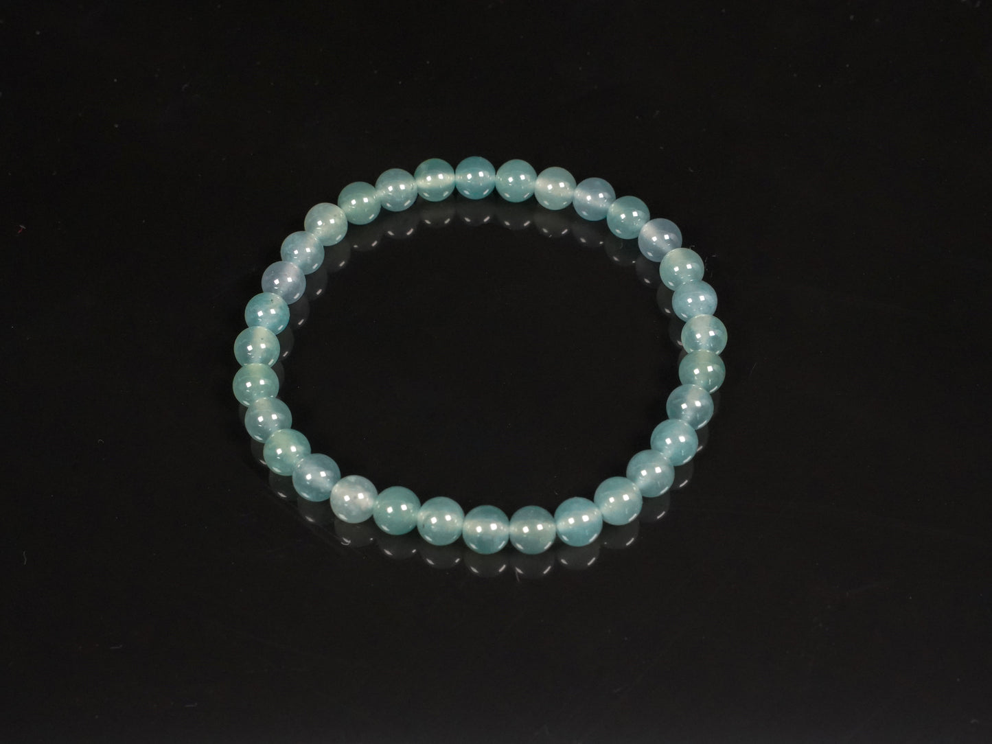 This is a pale lake-blue jadeite bracelet.