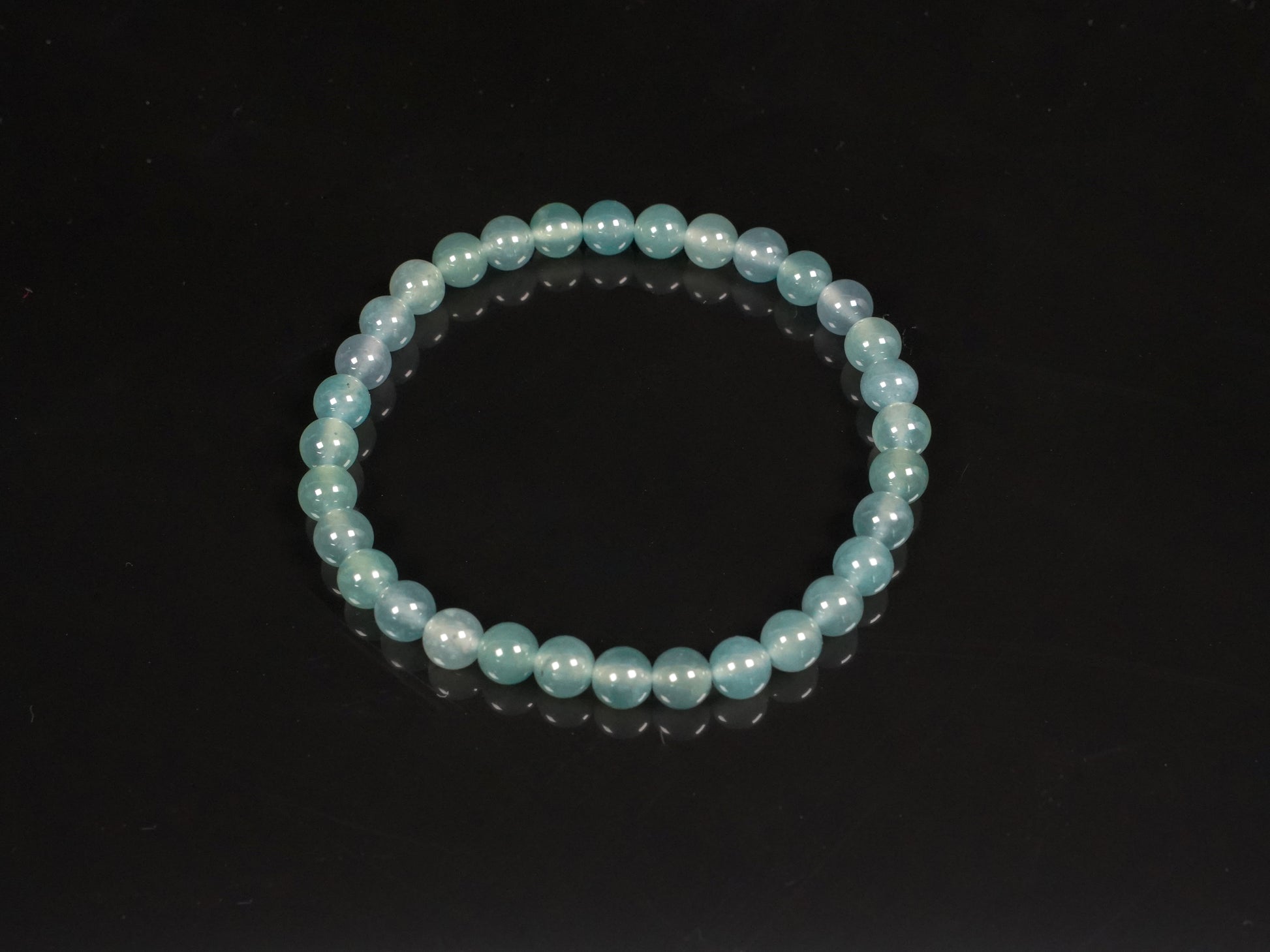 This is a pale lake-blue jadeite bracelet.