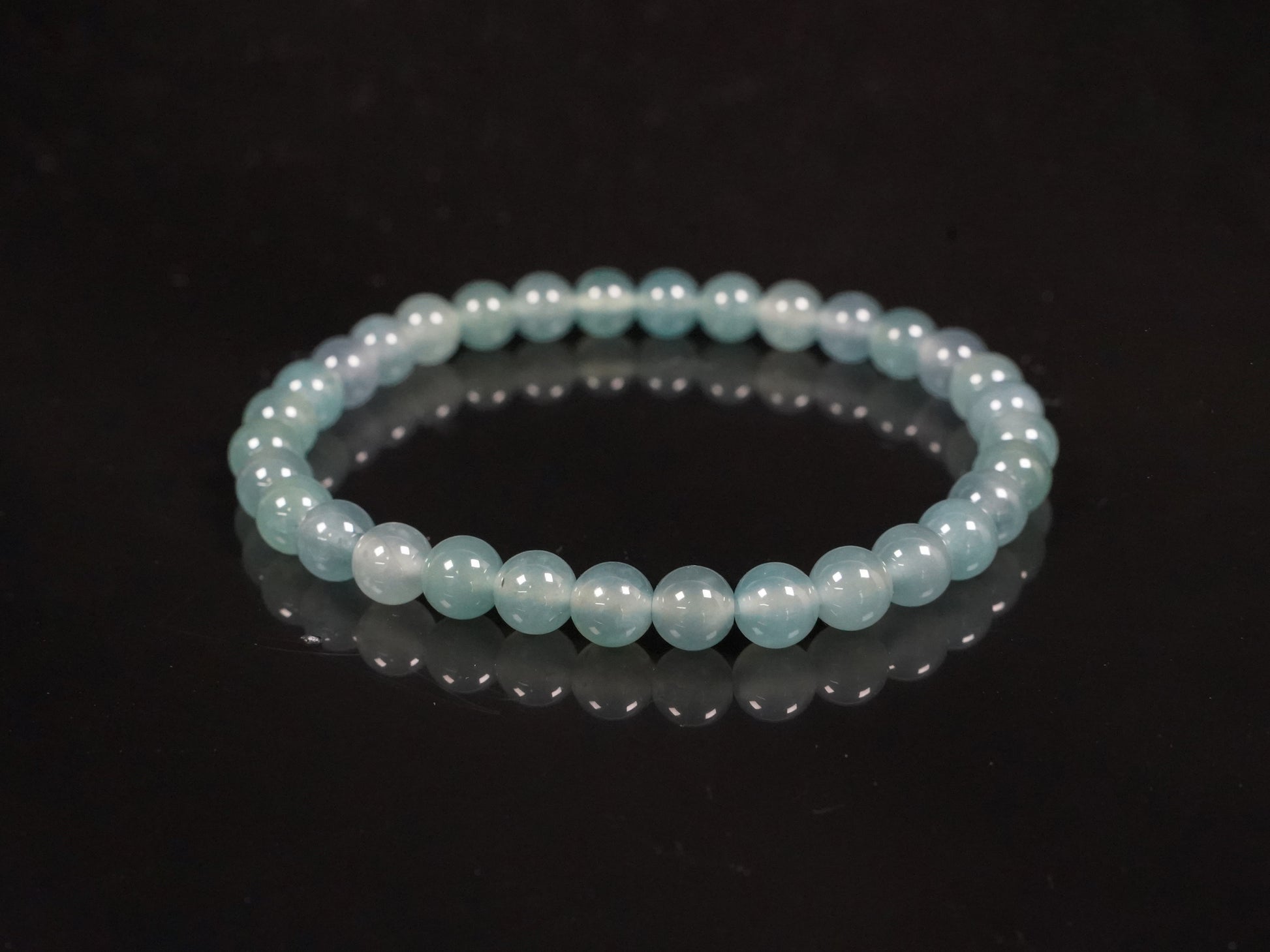 This is a pale lake-blue jadeite bracelet.