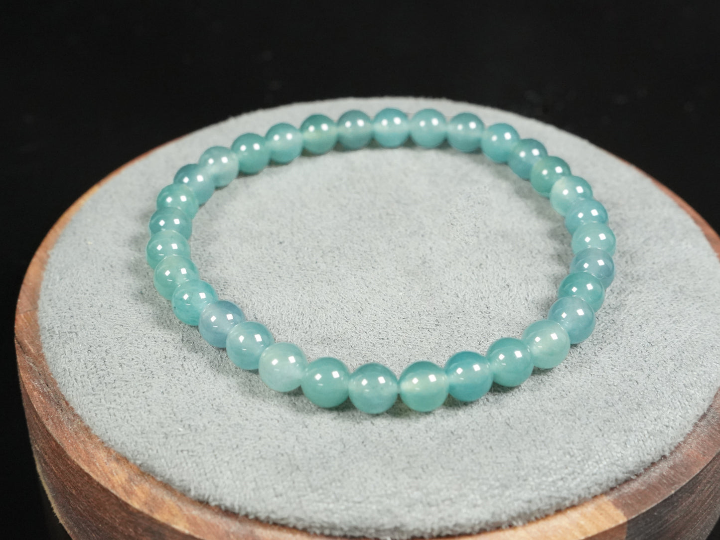 This is a pale lake-blue jadeite bracelet.