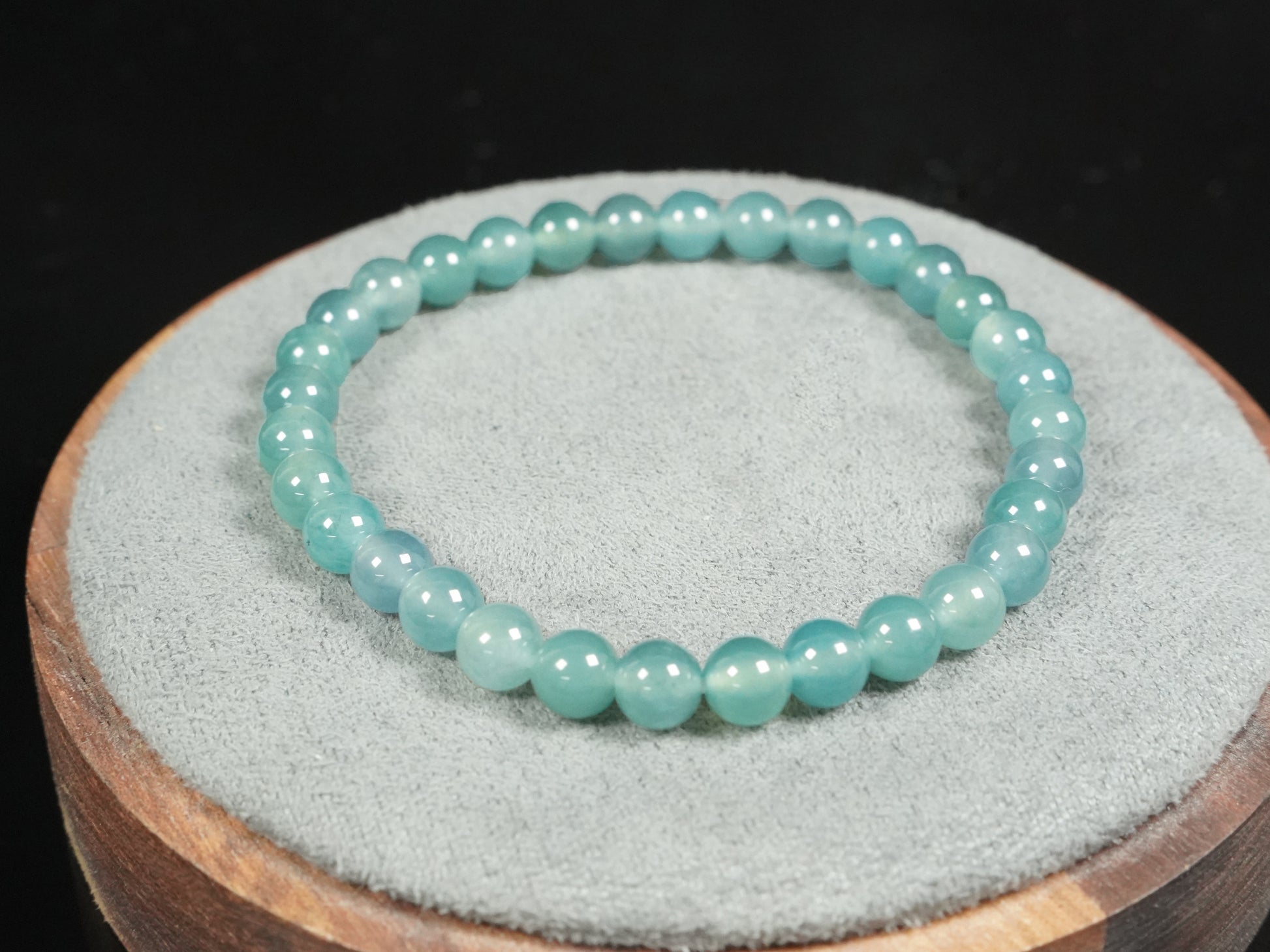 This is a pale lake-blue jadeite bracelet.