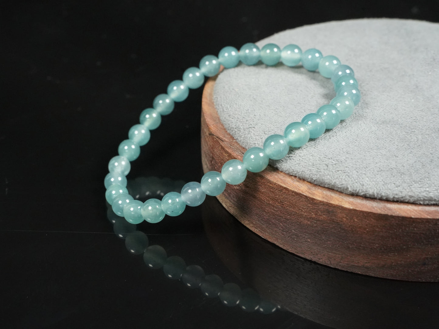 This is a pale lake-blue jadeite bracelet.