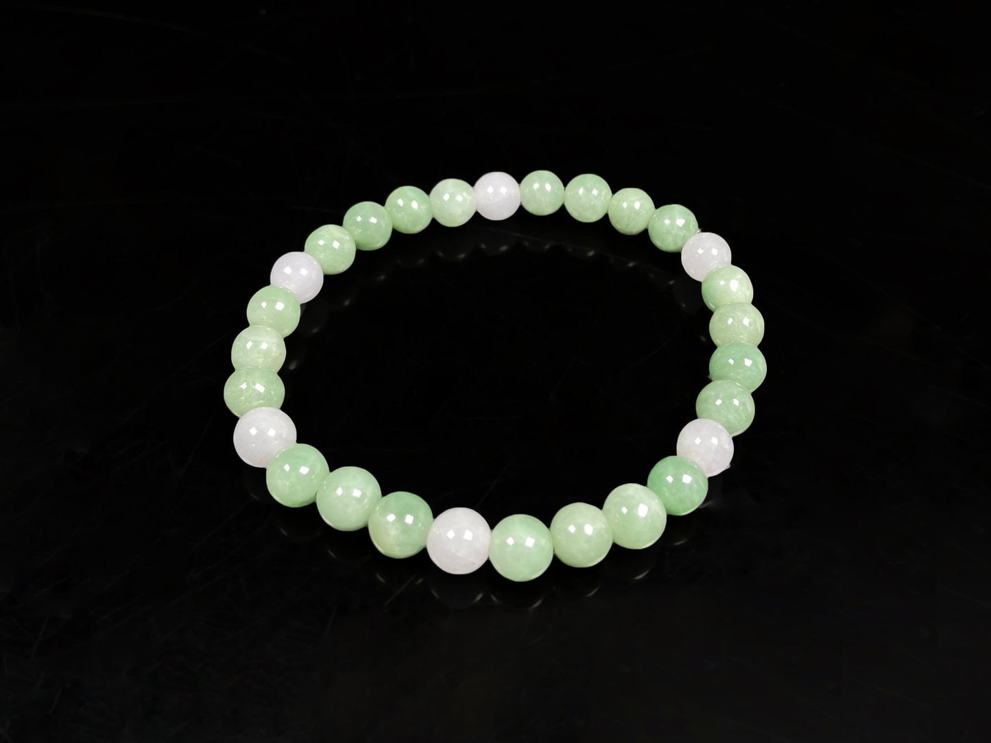 A verdant white peace jadeite beads bracelet.