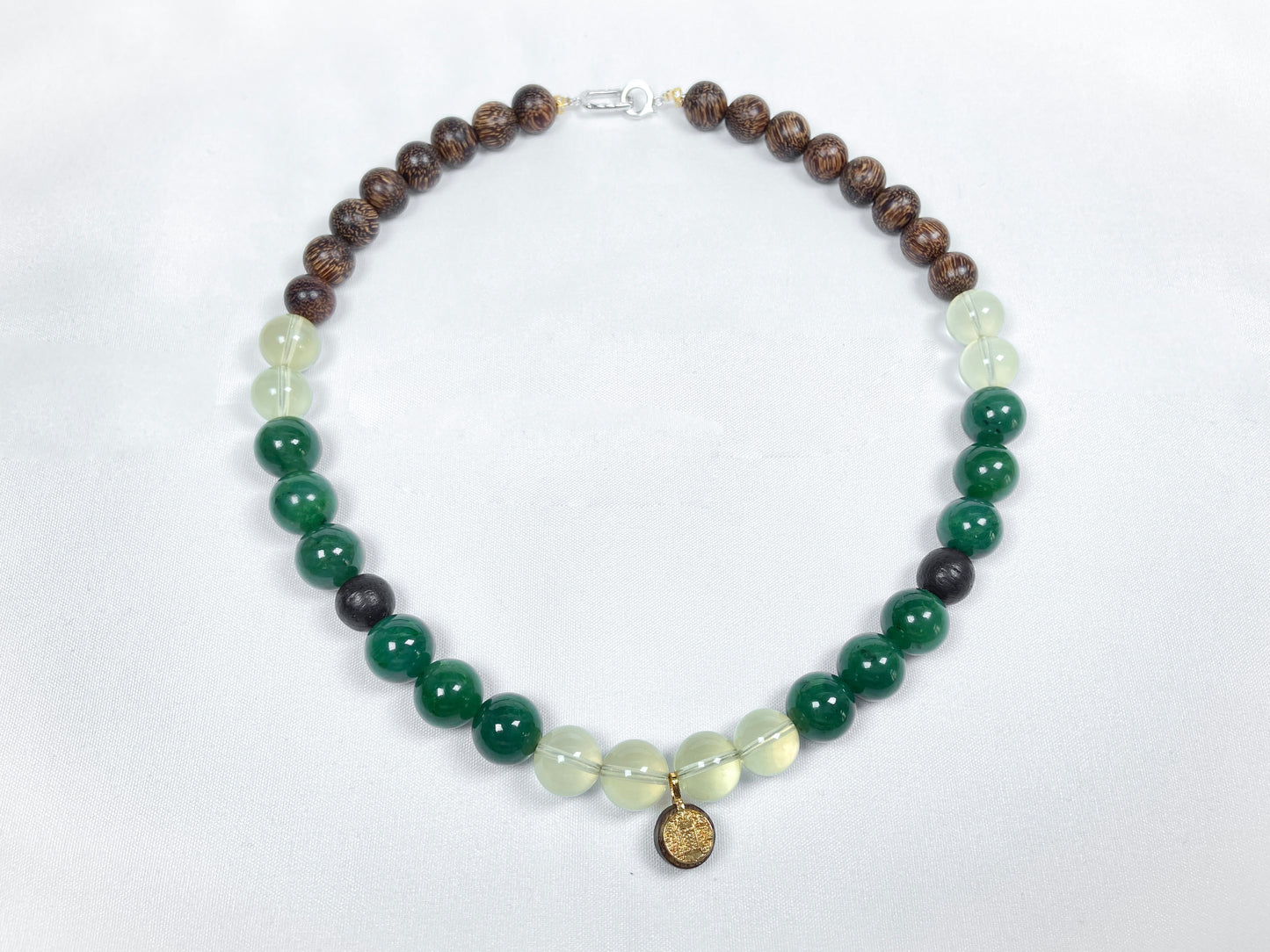 A necklace crafted from brown agarwood, green Hetian jade and yellow citrine beads.