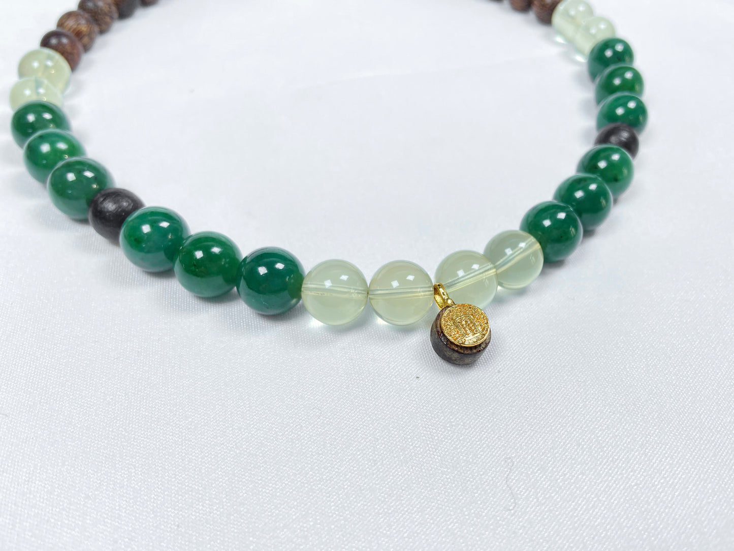 A necklace crafted from brown agarwood, green Hetian jade and yellow citrine beads.