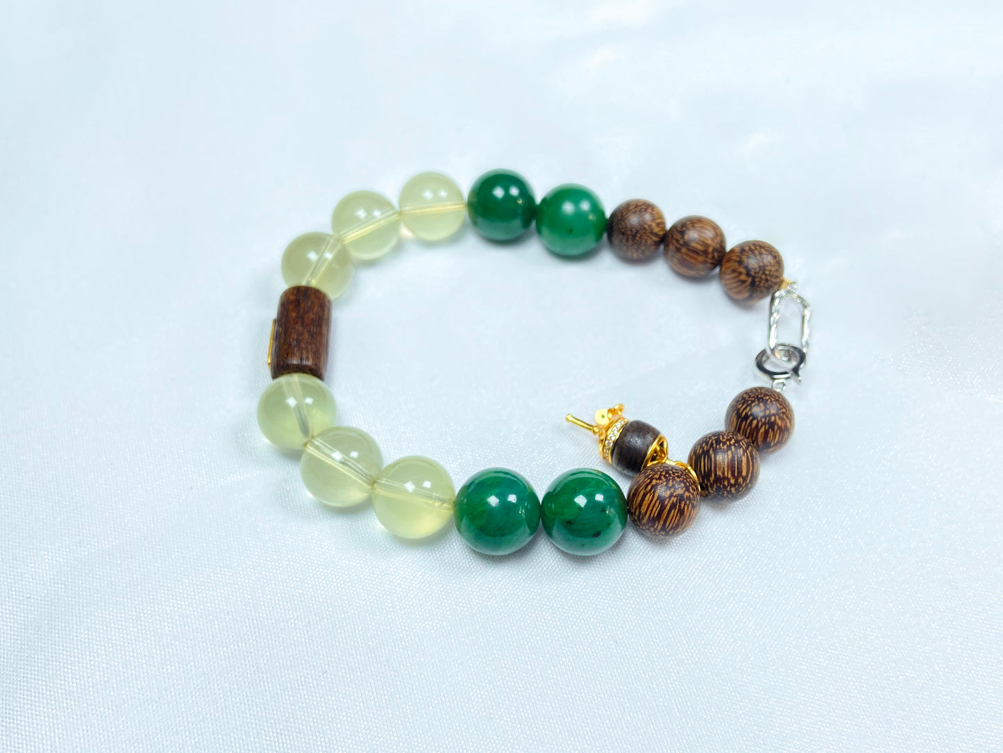 A bracelet crafted from brown agarwood, green Hetian jade and yellow citrine beads.