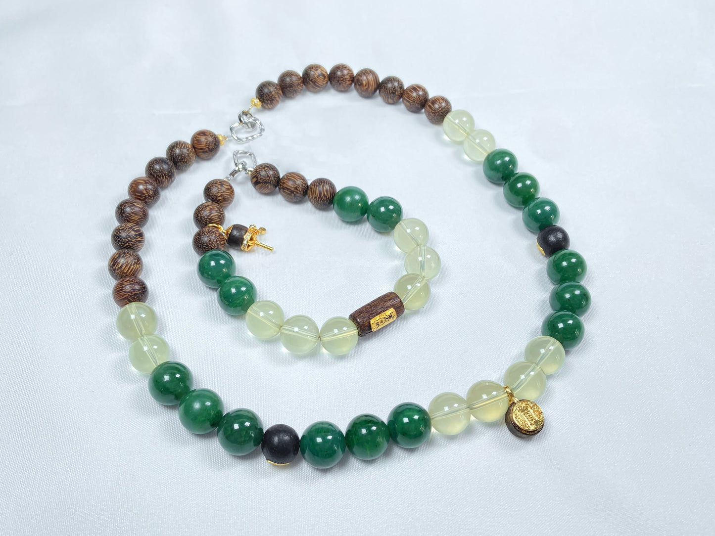 A necklace and bracelet crafted from brown agarwood, green Hetian jade and yellow citrine beads.