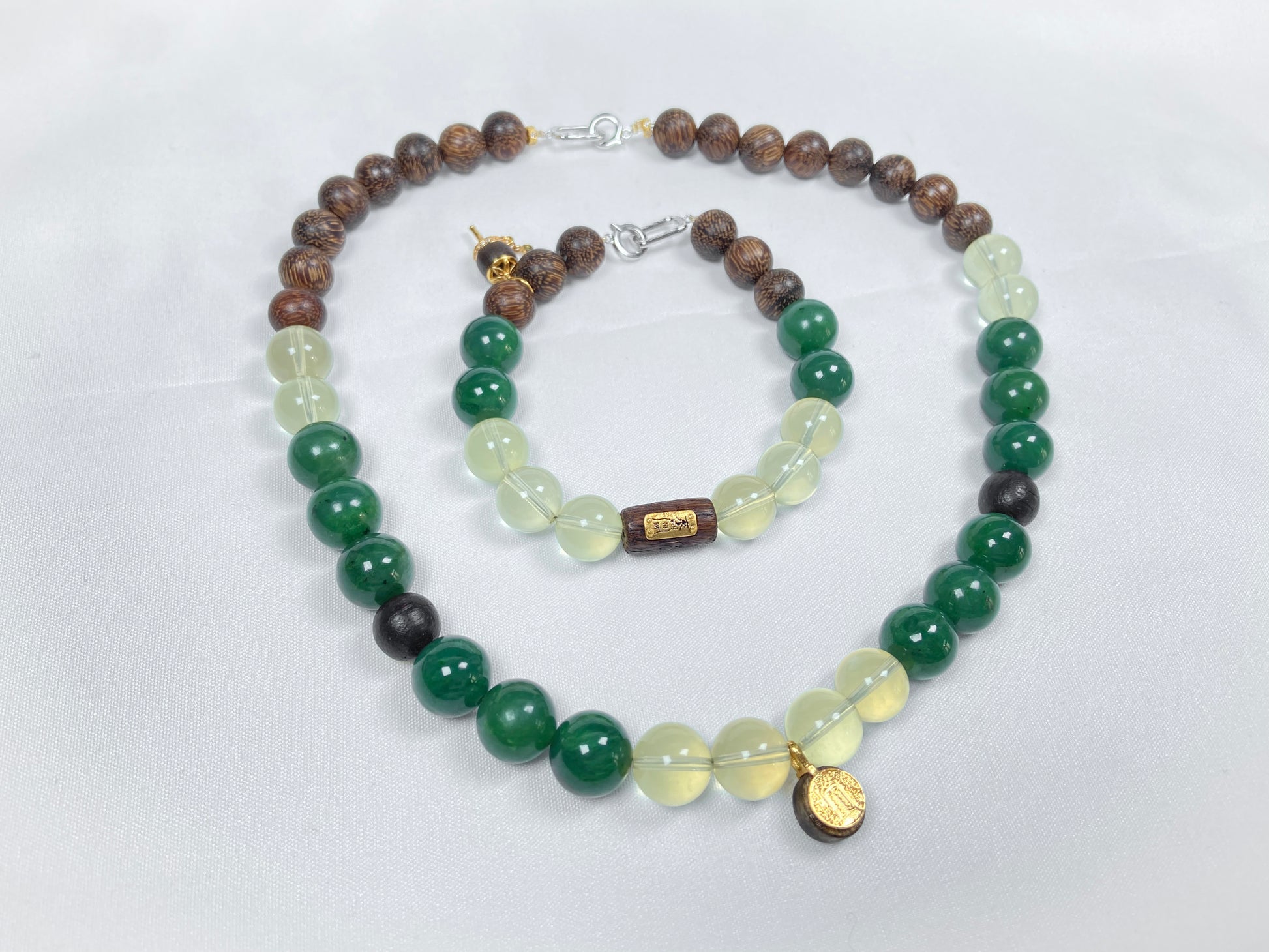 A necklace and bracelet crafted from brown agarwood, green Hetian jade and yellow citrine beads.