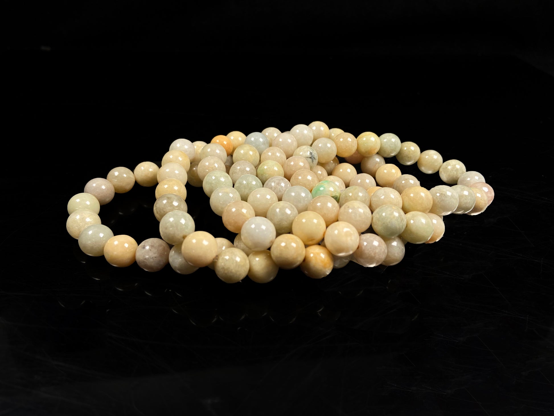 A warm beige serenity jadeite beads bracelet group.
