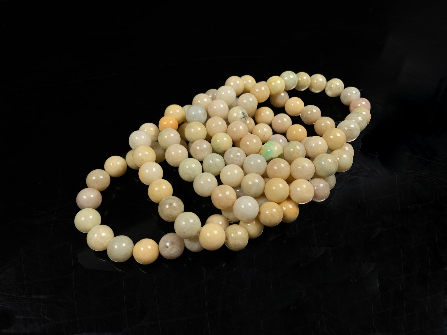 A warm beige serenity jadeite beads bracelet group.