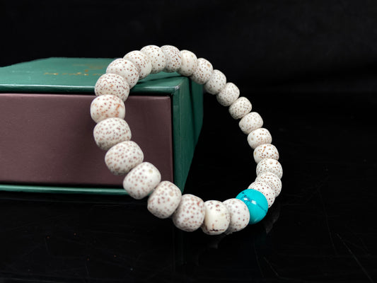 A crimson specks on cream star and moon bodhi beaded bracelet.