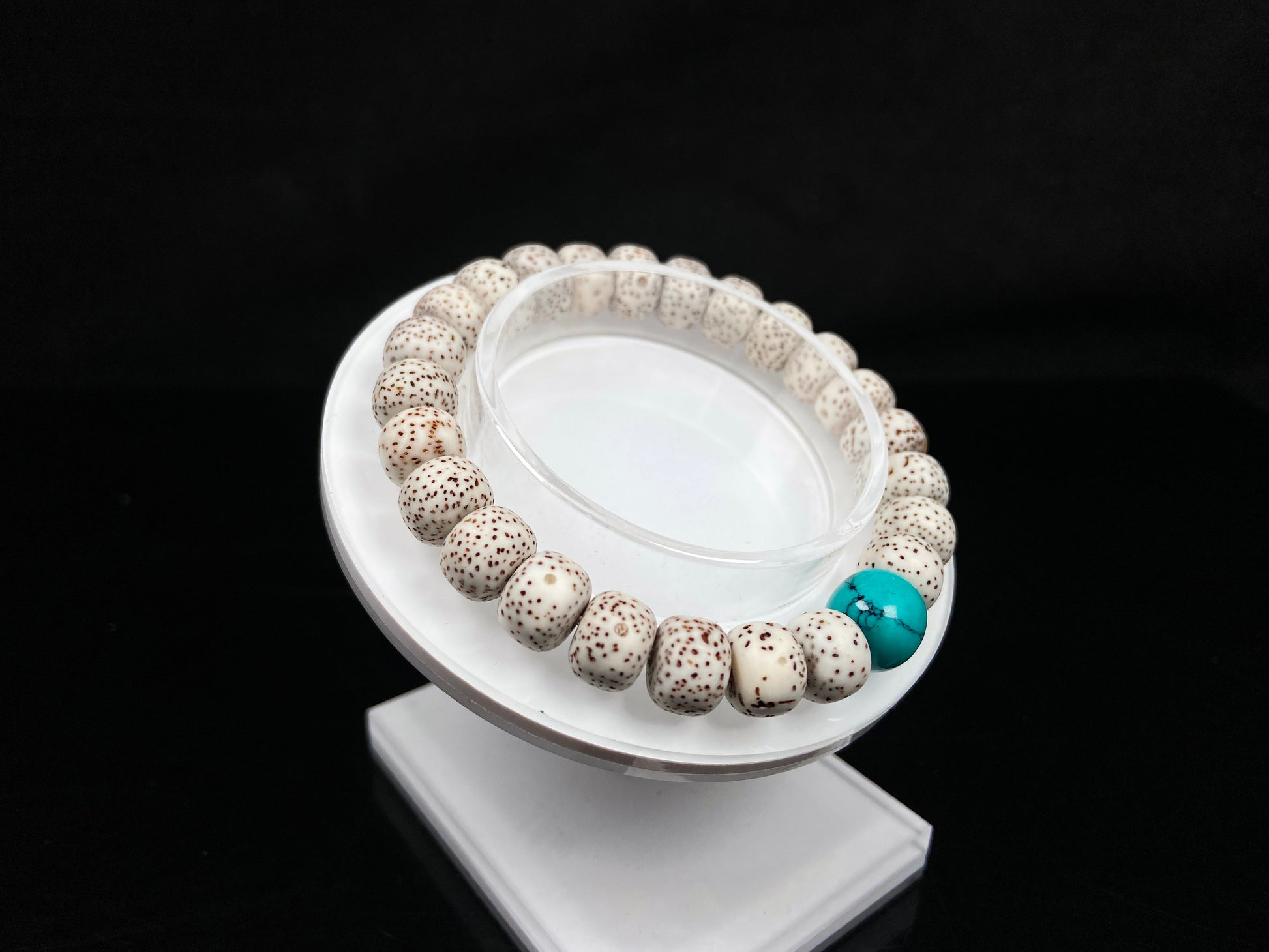 A crimson specks on cream star and moon bodhi beaded bracelet.