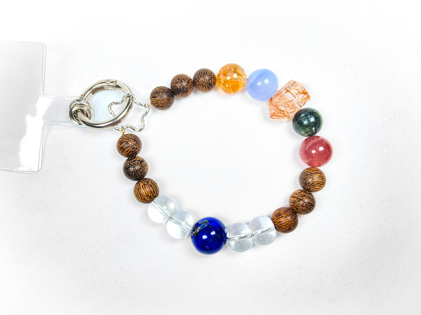 Multicolored beaded bracelet with a keychain on a white background