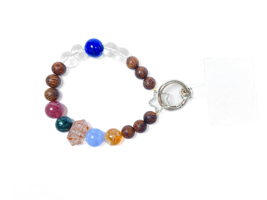 Multicolored beaded bracelet with a silver clasp on a white background