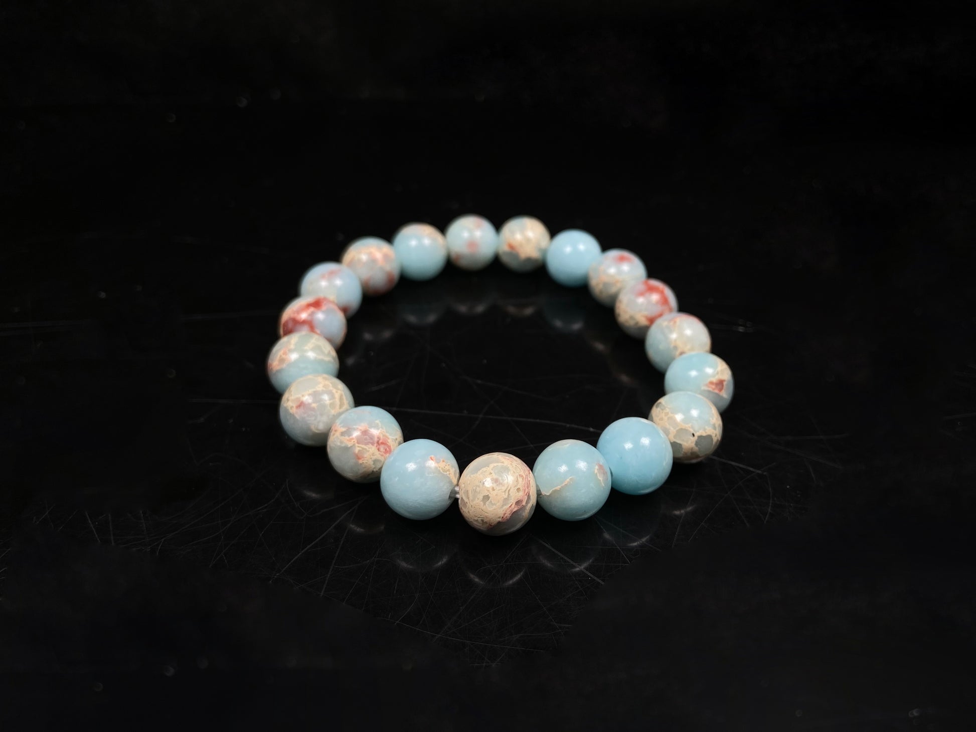 A red whispers in blue and white Shoushan stone beaded bracelet.
