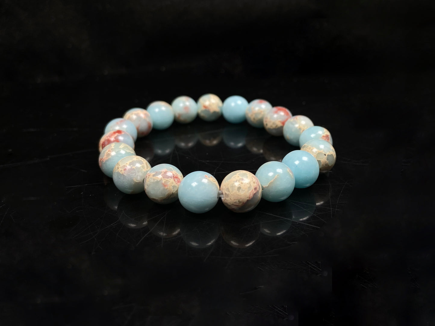 A red whispers in blue and white Shoushan stone beaded bracelet.