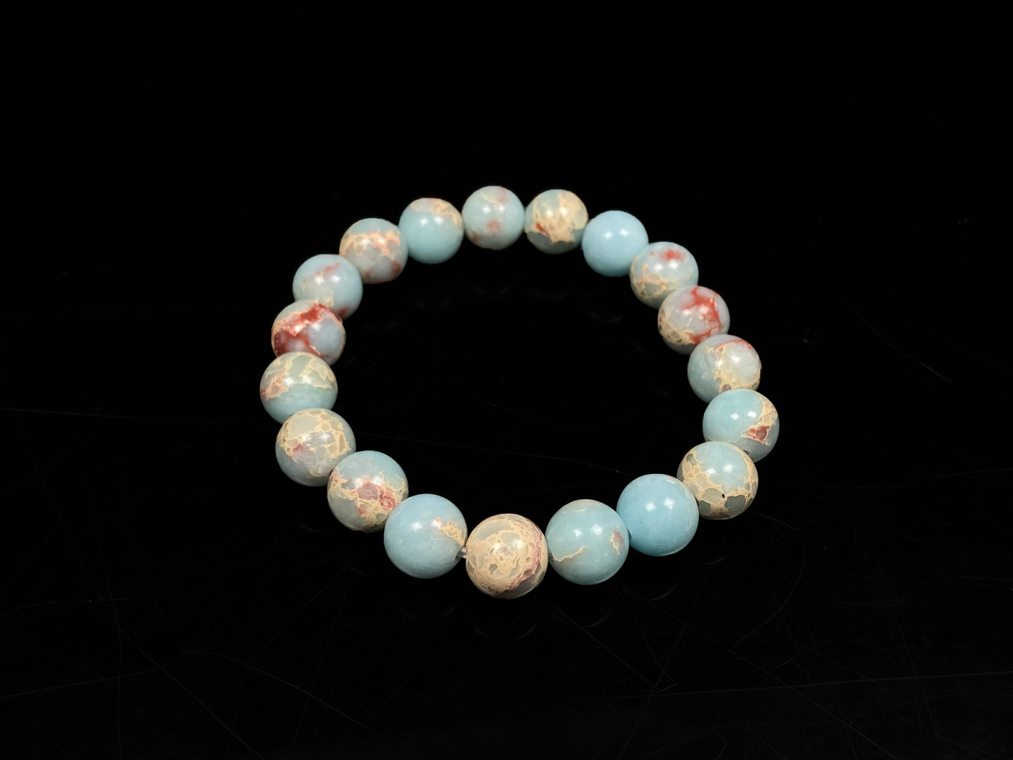 A red whispers in blue and white Shoushan stone beaded bracelet.