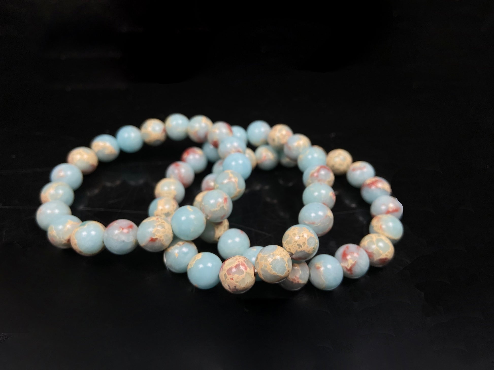 A red whispers in blue and white Shoushan stone beaded bracelet.