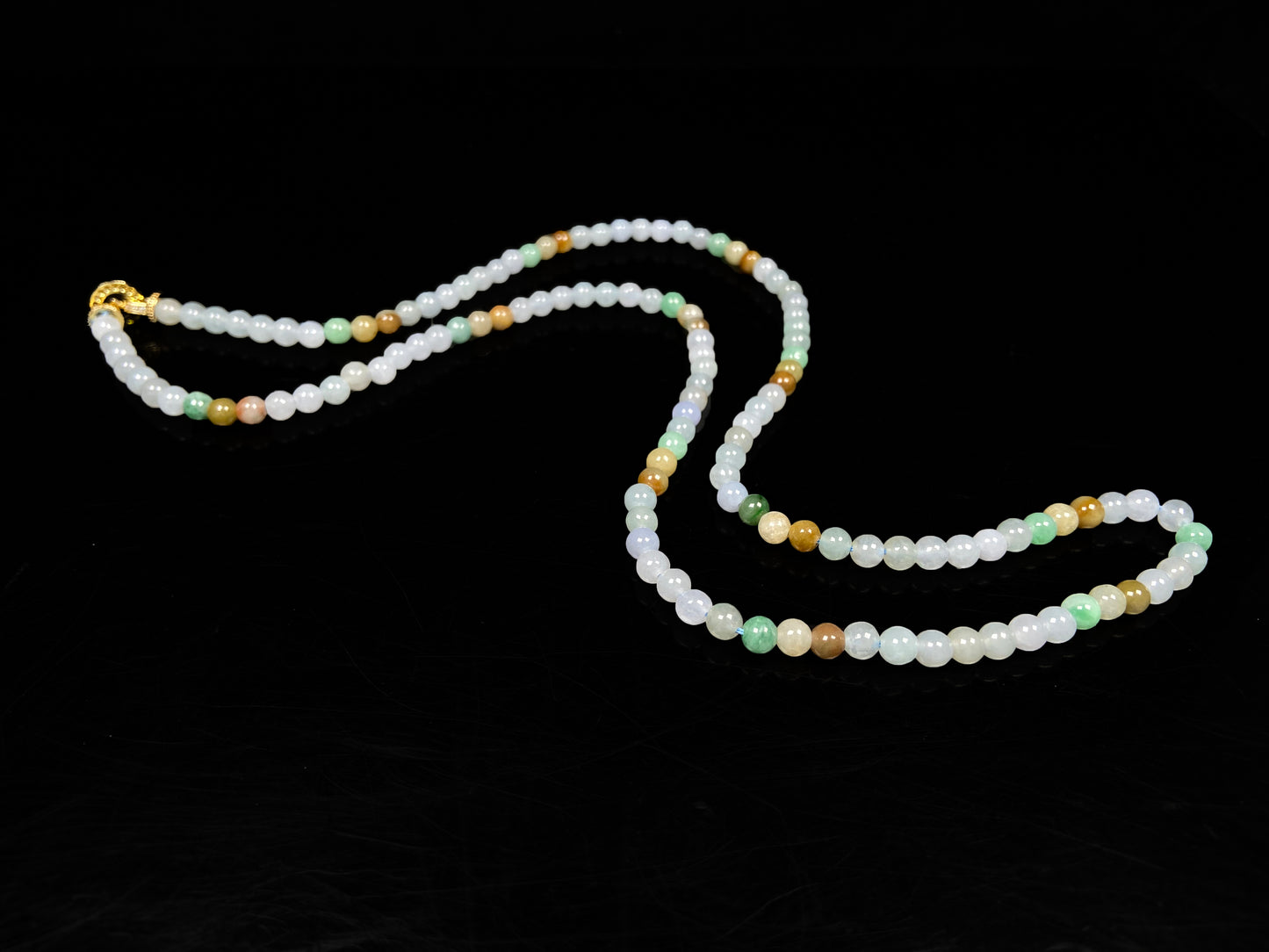 A soft glossy tri-color jadeite beads necklace.