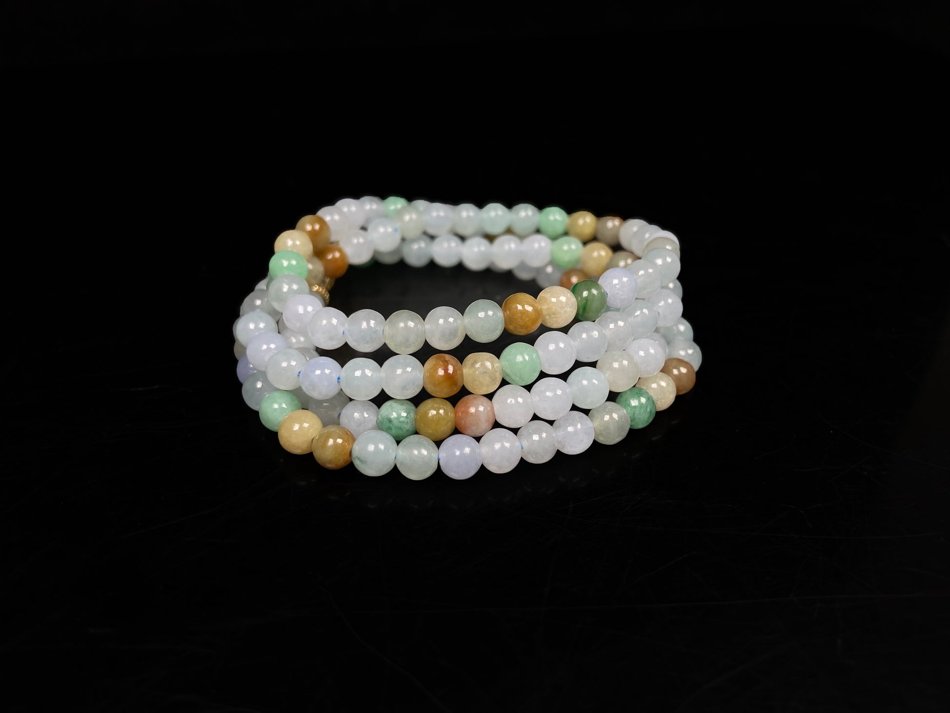 A soft glossy tri-color jadeite beads necklace.