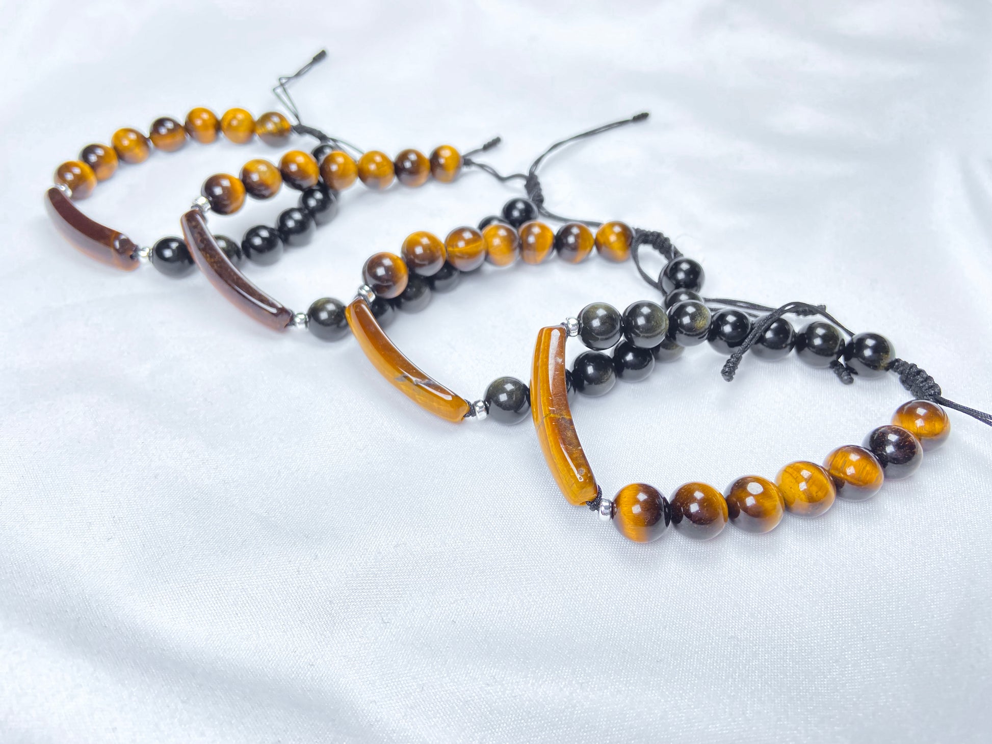 A group of black and gold contrast natural tiger's eye beaded bracelet.