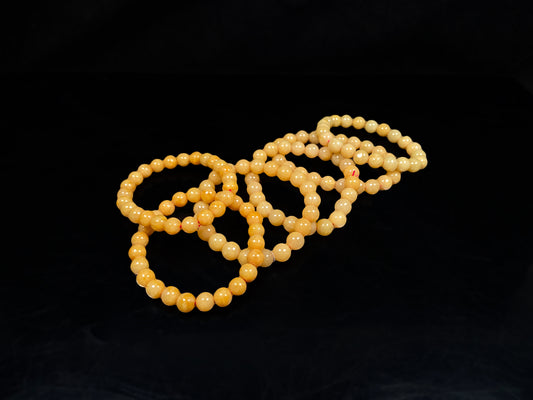 A  group of calm corn yellow jadeite beads bracelet.