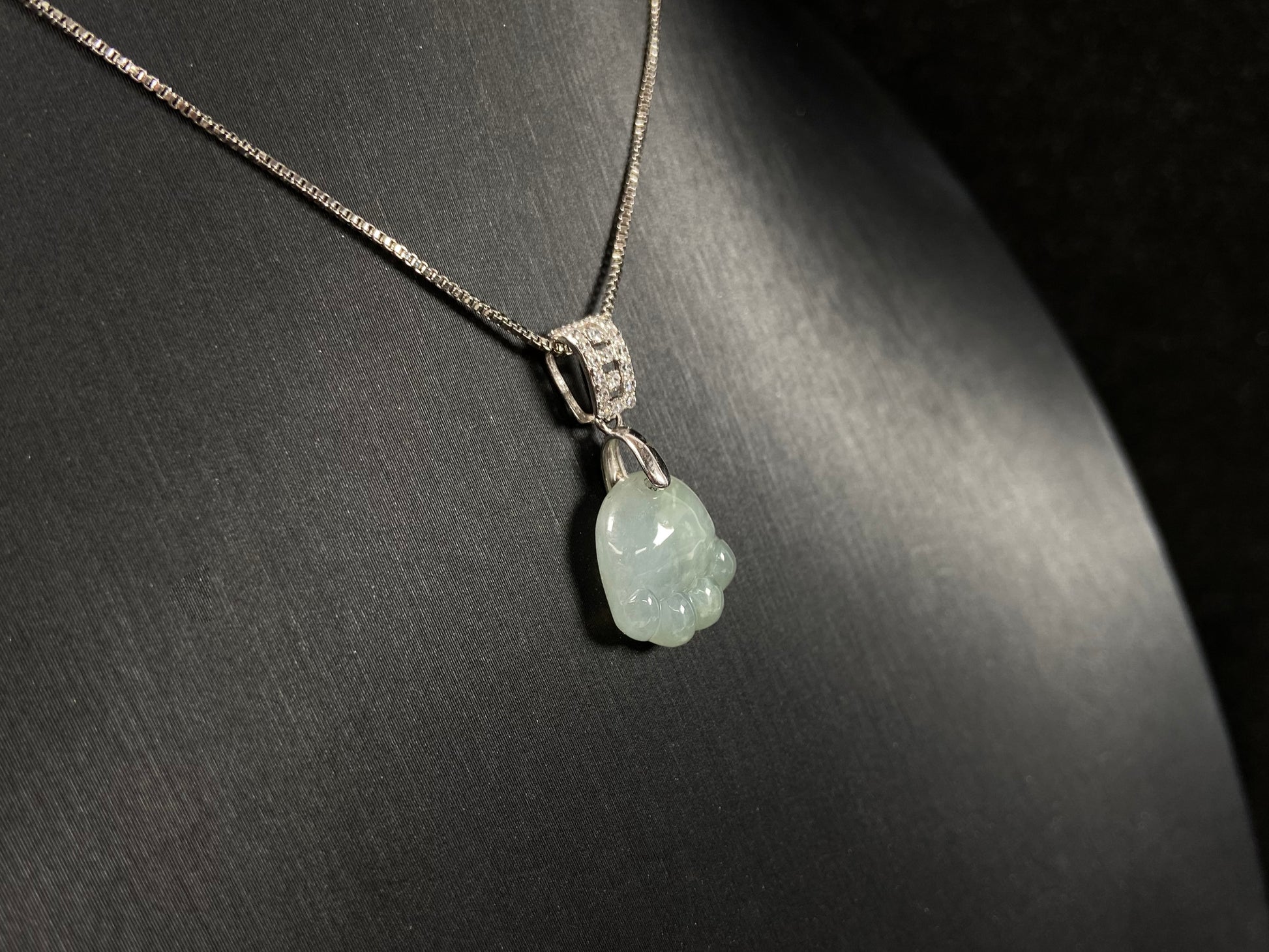 A light green jadeite cat paw pendant.
